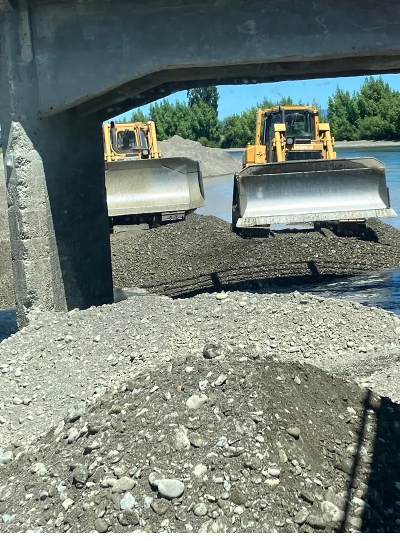 Dozers working below a bridge